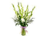 This alluring arrangement is full of elegance and class. With gorgeous white Snapdragons, ethereal green Gladiolus, beautiful soft filler and greenery.
