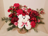 Introducing a fresh design for the beloved holiday dog! Crafted with vibrant carnations and aromatic greens, complete with a charming hat, this cheerful canine embodies the essence of the season. Sending this arrangement is a delightful way to extend warm wishes of "Merry Everything!" to your cherished ones.